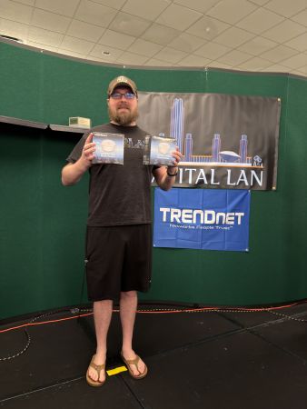 Attendee holding two TRENDnet boxes on stage
