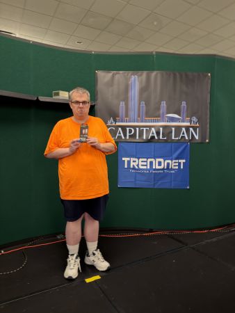 Attendee holding prize in front of Capital LAN and TRENDnet