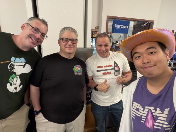 Group of four attendees posing indoors