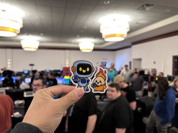 Hand holding event-themed stickers