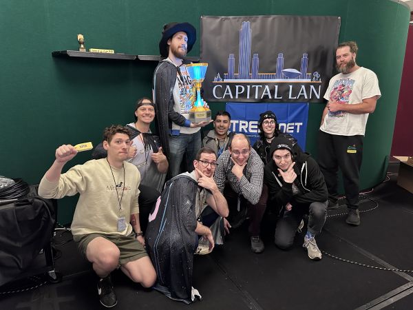 Group posing with Capital LAN trophy