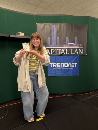 Attendee holding award on stage