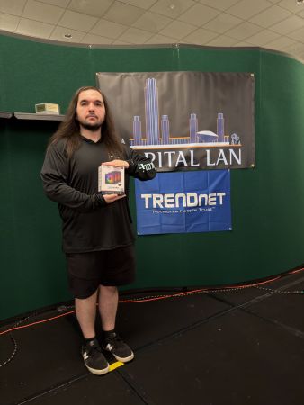 Attendee holding a boxed prize on stage