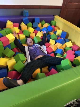 Person lying in foam cube pit