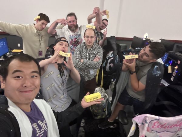 Group of attendees posing with butter-shaped objects