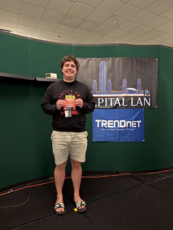 Attendee holding a prize card on stage