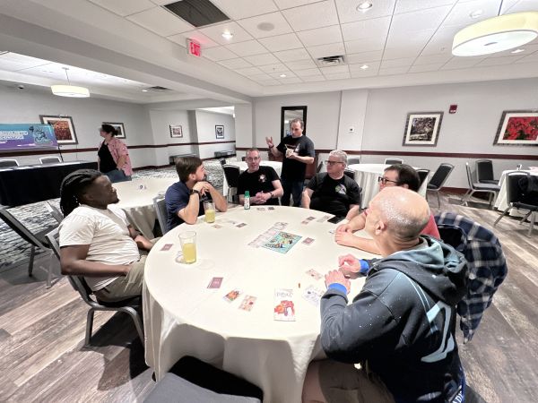 Group playing a card game at a round table