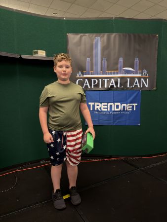 Attendee standing in front of Capital LAN and TRENDnet banne