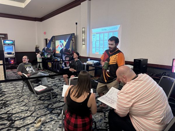 Group reviewing game materials in tabletop hall