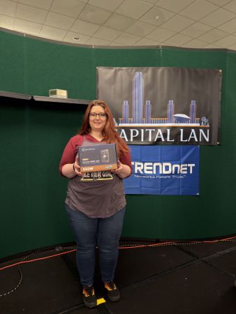 Attendee holding computer power supply prize