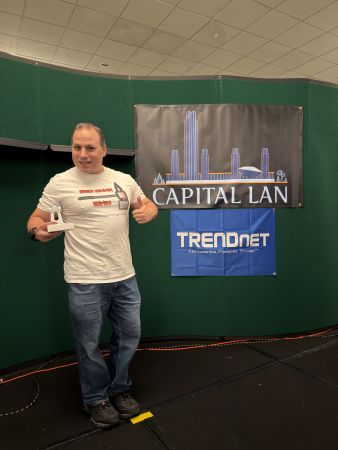 Attendee posing with trophy on stage