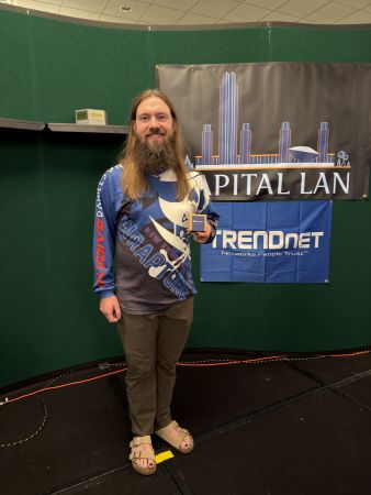 Attendee holding a small prize box on stage