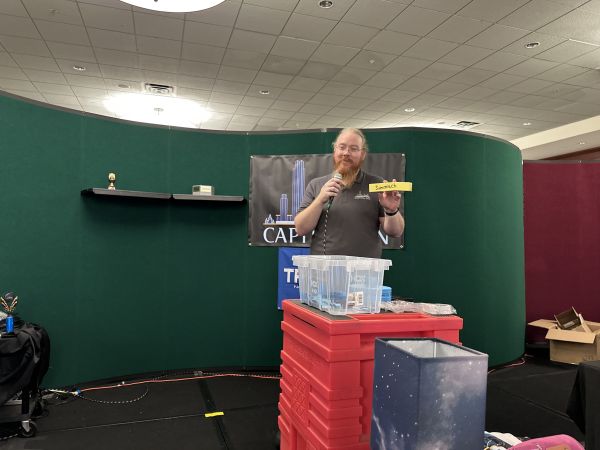 Person holding raffle ticket on stage