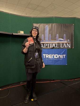 Attendee holding a game box on stage
