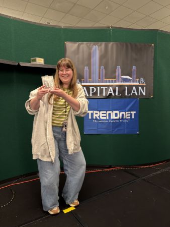 Attendee holding award on stage