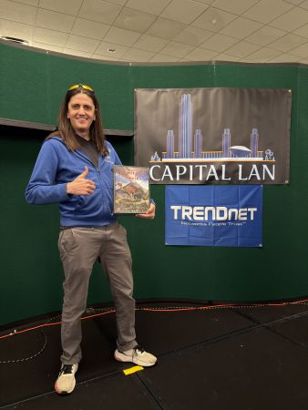 Attendee holding board game prize on stage