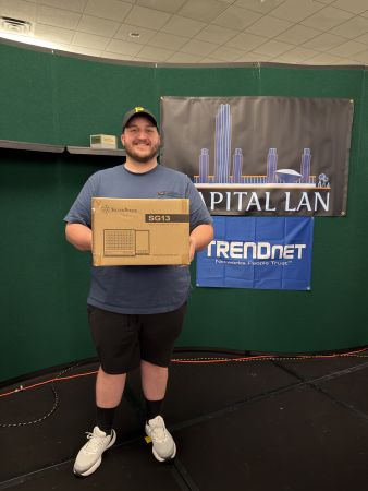 Attendee holding a boxed SilverStone SG13 computer case