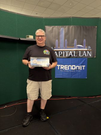 Attendee holding TRENDnet mesh router prize