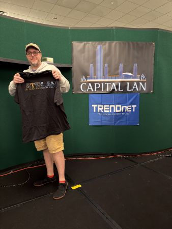 Attendee holding a t-shirt on stage