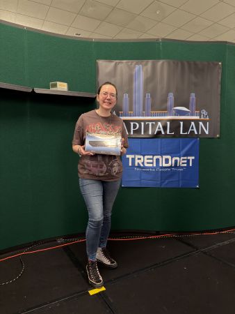 Attendee holding a prize box on stage