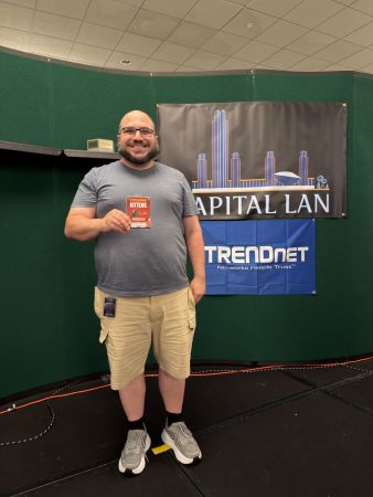Attendee holding a game box on stage