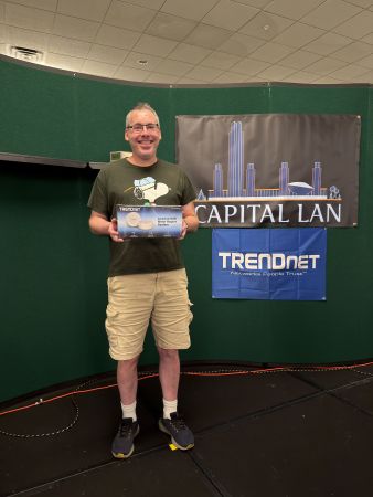 Attendee holding a TRENDnet AC2200 WiFi Mesh Router prize