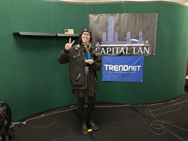 Attendee holding trophy on stage